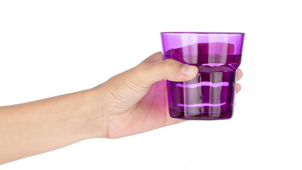 Hand holding purple glass isolated on white background.