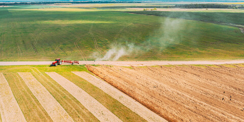 Aerial View. Tractor Plowing Field In Spring Season. Beginning Of Agricultural Spring Season....
