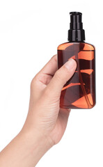 Hand holding Hair serum bottle isolated on a white background.