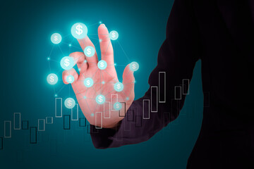 Hand with black suit point usd $ symbols with candlestick chart on blue and black background. plant investment income money from stock market trade global in 2022 new year. technology for business.