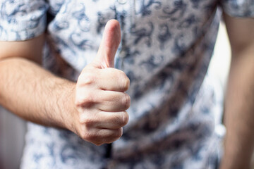 Close up image of man showing thumbs up thumbs up of success. Approval gesture, satisfaction