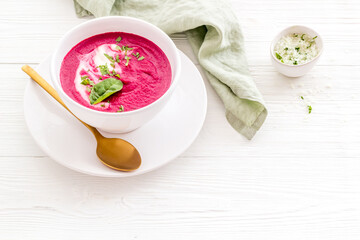 Red vegetarian beet root cream soup with herbal basil salt