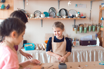 pottery workshop for kids, girl working with clay