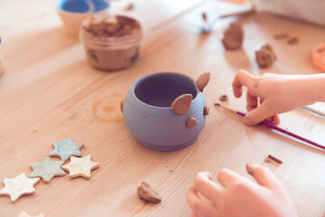 pottery workshop for kids, girl working with clay