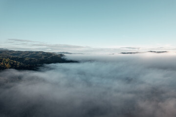Naklejka na ściany i meble morning fog in the mountains rainy season