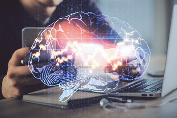 Double exposure of man's hand holding and using a digital device and brain hologram drawing. Data concept.