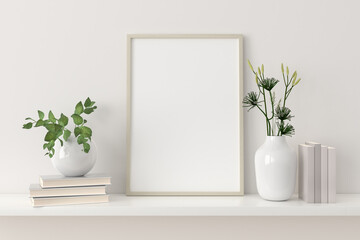Empty picture frame mockup on a shelf with books and plants in porcelain vases.