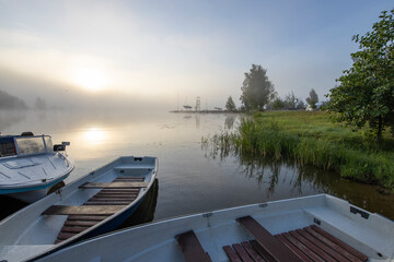 Early morning. Fog on the river. Beautiful sunrise in the summer by the river. boats at the pier.