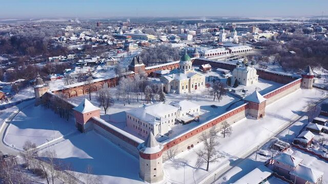 View from drone of snow covered architectural ensemble of Zaraysk Kremlin with Forerunner and St. Nicholas cathedrals on winter day, Russia