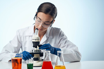 laboratory assistant in a white coat work table microscope diagnostics biotechnology