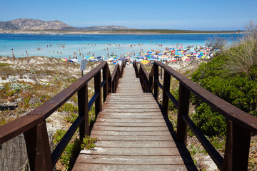 Fototapeta na wymiar Footbridge to the beach of La Pelosa in Stintino, Sardinia, Italy