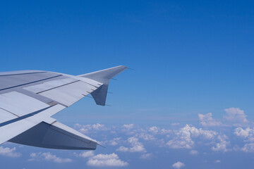 Aerial view of clouds and sky as seen through the window of an aircraft