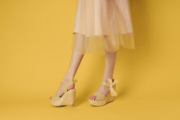 womens shoes beige yellow background posing fashion