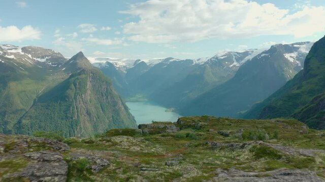 Overview Of Oldevatnet From Klovane Peak In Olden, Norway With Tourist Hikers. drone pullback