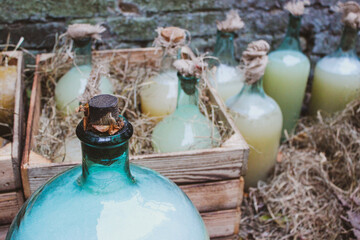 Vintage homemade moonshine bottles in wooden cases

 - obrazy, fototapety, plakaty