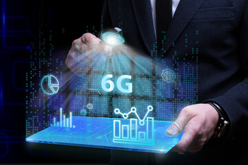 Business, Technology, Internet and network concept. Young businessman working on a virtual screen of the future and sees the inscription: 6G