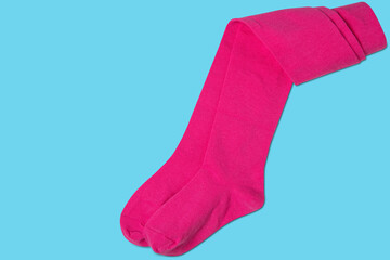baby pink tights, on cyan background, half rolled up