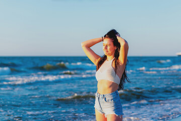 Young woman playing in the sea.woman enjoying in sea water .Cheerful young woman having fun on the summer beach.