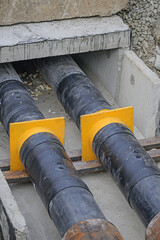 The heating pipes are mounted in an impassable channel made of reinforced concrete