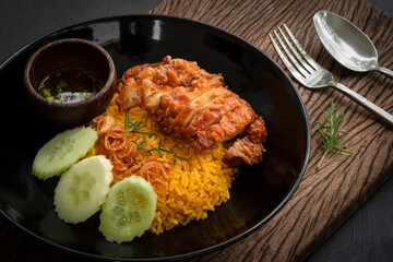 closeup Muslim yellow rice with fried chicken