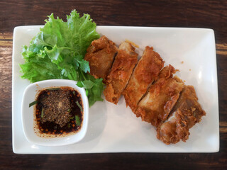 A plate of fried chicken and sauce thai food. Top view.