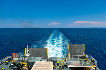 Trail on water surface behind of cruise ship