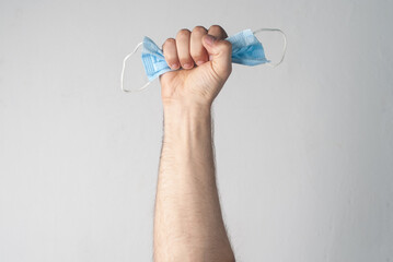 fist with a medical mask on a white background