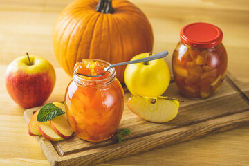 Fresh homemade pumpkin apple marmalade jam in glass jar on a wooden background. Several fresh...