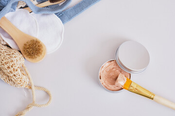 makeup brush and cosmetic red clay in aluminum jar, natural cosmetics and zero waste lifestyle