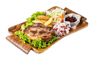 Gourmet meal of marinated pork  served with potatoes and sauce on wooden plate, isolated on white.