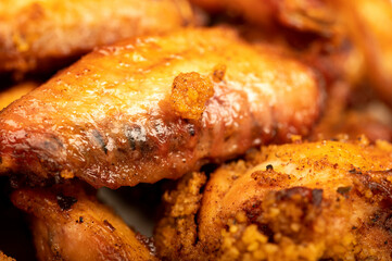Fried chicken wings on a plate, close-up, selective focus.