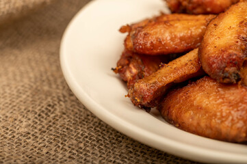 Fried chicken wings on a plate, close-up, selective focus.