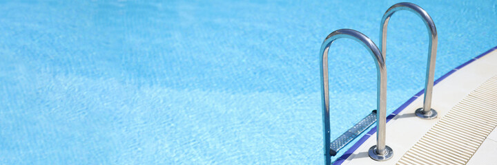 Chrome plated ladder to enter pool closeup