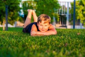 The child spends time in the park, he is very happy. Have fun and enjoy a summer day. Walking and recreation.
