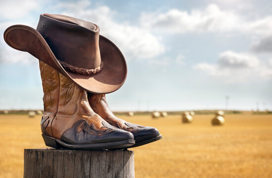 Cowboy hat and boots at ranch, country music festival live concert or line dancing concept