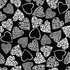 Seamless pattern of hearts with different textures. Elements of white on a black background. Cute background with hearts. Valentine's Day. Vector illustration.