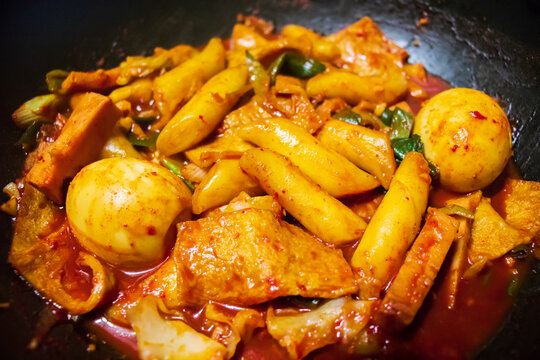 Korean food, tteokbokki. It is made with various kinds of ingredients such as rice cake, cabbage, fish cake, mushroom, boiled egg, noodle and red pepper paste.