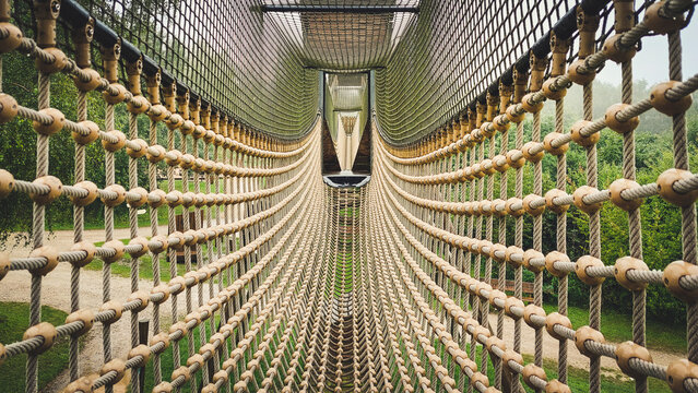 Fototapeta Suspension bridge with rope and mesh nett on a playground for children