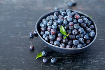 fresh blueberries on dark wooden surface