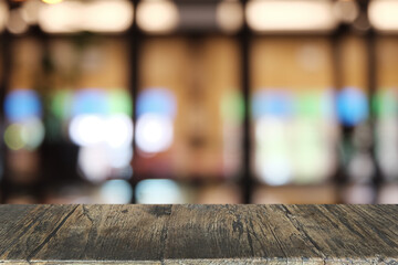 Empty dark wooden table in front of abstract blurred bokeh background of restaurant . can be used for display or montage your products.Mock up for space.