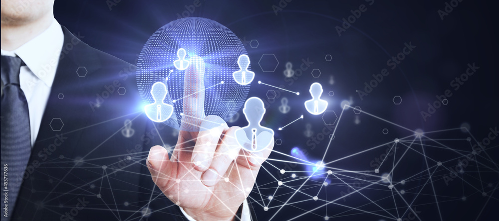 Poster Businessman hand using glowing globe interface with people icons on dark background. Social networking and recruiting concept.