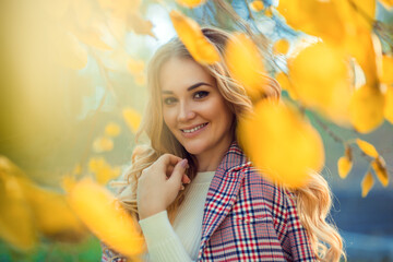 Outdoor atmospheric lifestyle photo of young beautiful lady. Blond hair and eyes. Warm autumn. Warm spring