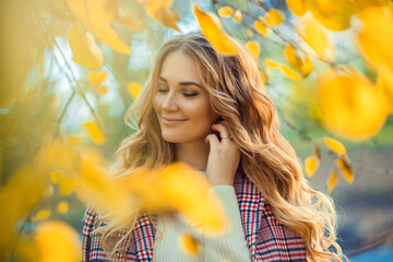 Outdoor atmospheric lifestyle photo of young beautiful lady. Blond hair and eyes. Warm autumn. Warm...