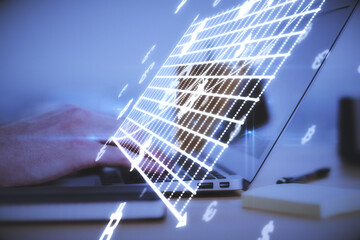 Close up of hands at desk using laptop computer with abstract glowing money mesh on blurry background. Cryptocurrency and online banking concept.
