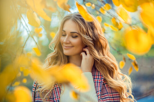 Outdoor atmospheric lifestyle photo of young beautiful lady. Blond hair and eyes. Warm autumn. Warm spring