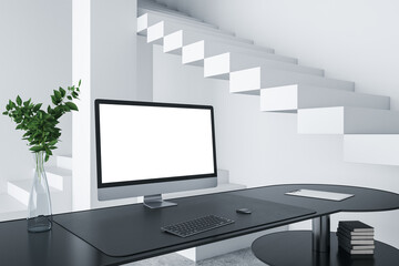 Close up of creative designer desktop with empty white computer screen frame, decorative items and modern interior in the background. Mock up, 3D Rendering.