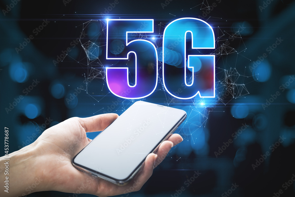 Poster close up of hand holding smartphone with abstract glowing 5g hologram on dark blue background. wirel