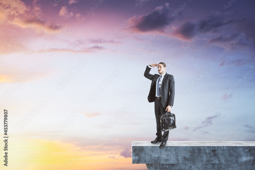 Poster man on abstract concrete edge looking into the distance on creative bright sky background with mock 