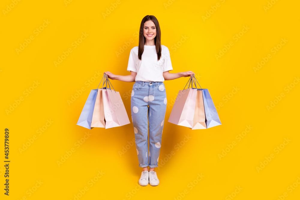 Sticker full size photo of happy smiling good mood beautiful woman hold shopping bags isolated on yellow col