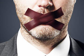 Close up of taped caucasian businessman mouth. Silence and speech censorship concept. - obrazy, fototapety, plakaty